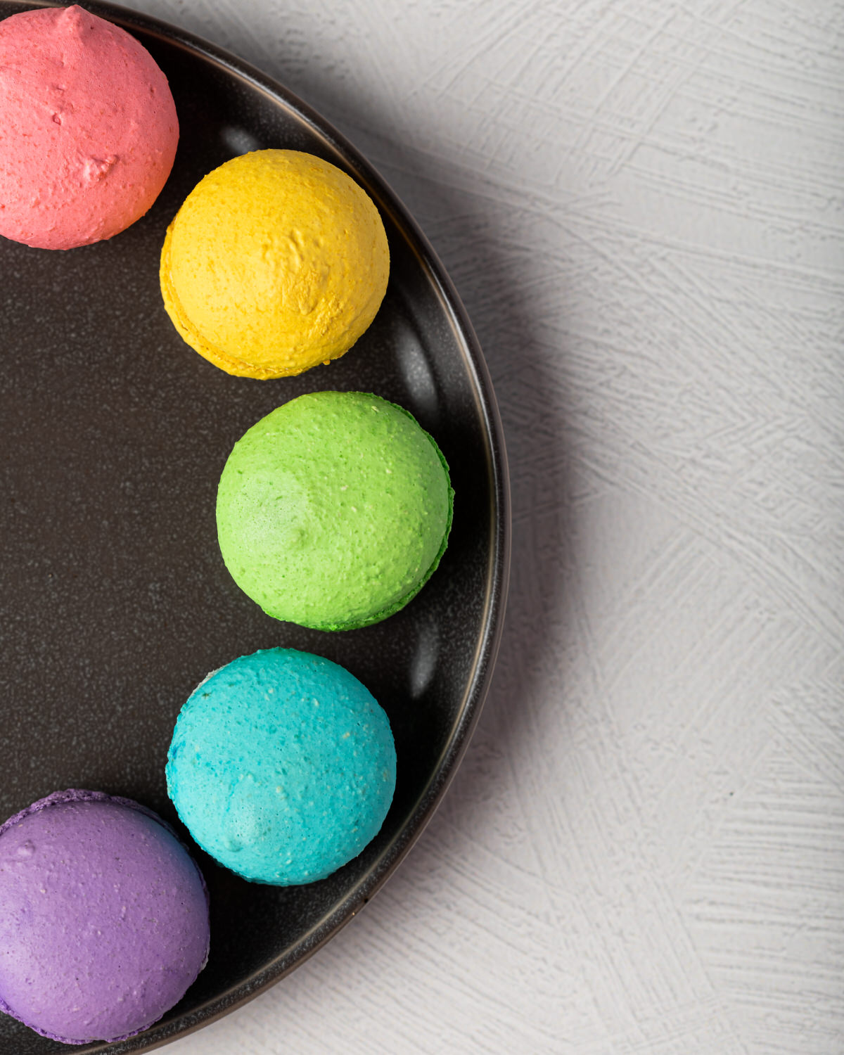 Colorful macarons on a dark plate Columbus MS food photographer